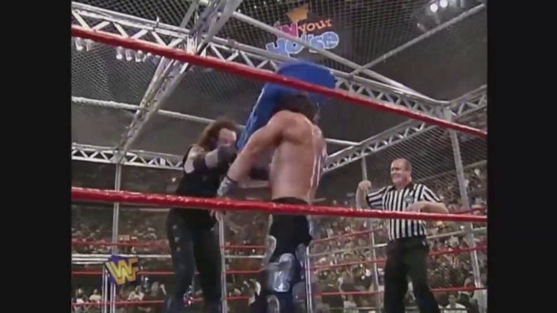 The Undertaker mashes HBK's noggin with a brutal chair shot.